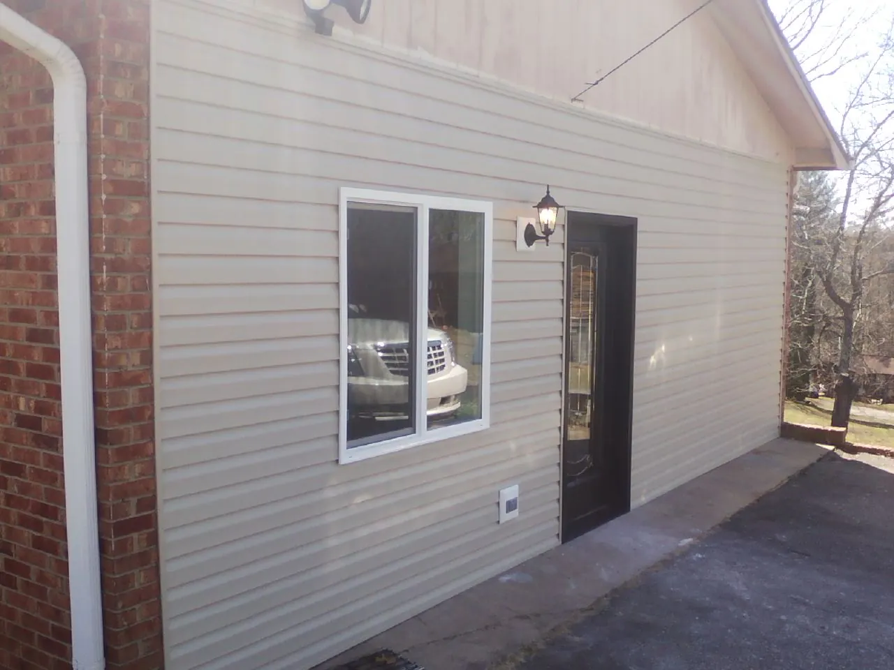 New vinyl siding and entry door on a room addition in Stamping Ground