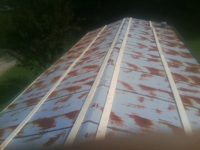 Rusted metal roof panels with new wood purlins before replacement — Storm Damage Roof Repair in Stamping Ground by Roofing Brothers